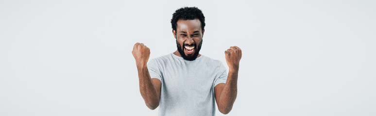 Fototapeta premium successful african american man in grey t-shirt gesturing isolated on grey