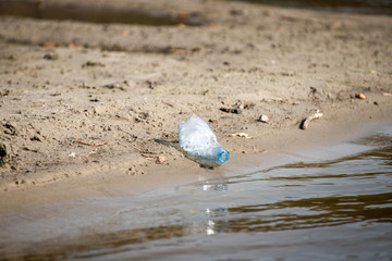 plastic trash bottle on beach. Pollution concept photo