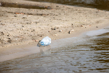 Obraz premium plastic trash bottle on beach. Pollution concept photo