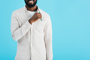 Fototapeta premium cropped view of smiling african american man with pencil isolated on blue