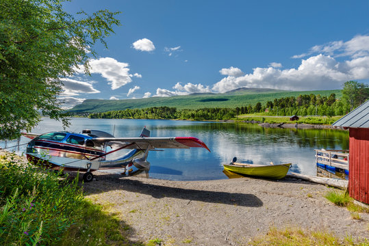 The Hydroplane and motorboat in the border of Hornavan lake in Swedish Lapland, the deepest lake in Sweden. Peljekaisse mountain is at background. Norrbotten county, Norrland.