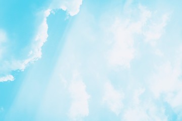 Beautiful white soft fluffy clouds on a sky background. Sunlight, light and shadow. Blue turquoise toned