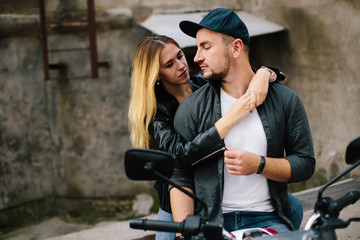 Plakat Couple on motorbike near old building
