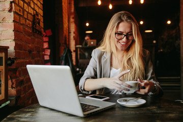 Young business woman working in cafe