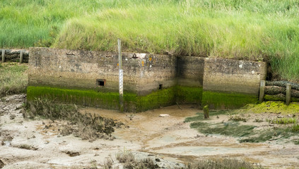 Fototapeta na wymiar Half buried bunker on the North Norfolk coast, UK
