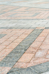 Natural stone laid on the pavement with a pattern.
