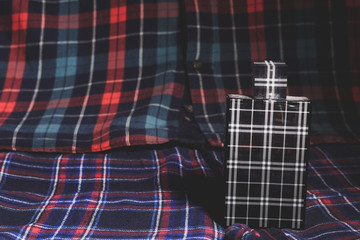 Checked perfume bottle, shirt and trousers