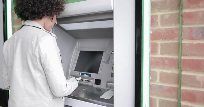 Closeup of woman using an ATM