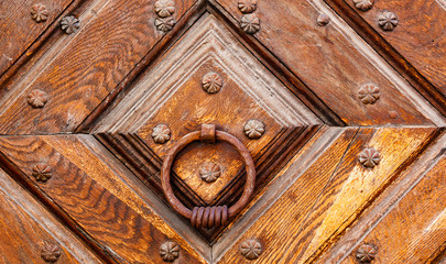 Vintage wooden door with rivets round knocker