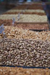 Variety of nuts on market counter, close-up. Mix of fresh nuts