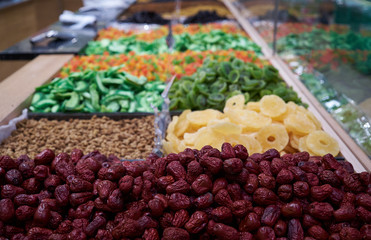 Dried fruit in market counter, close-up. Mix of sweet dried fruits