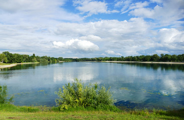 Naklejka na ściany i meble Beautiful lake horizon with white clouds and reflection