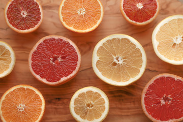 Citrus fruit (oranges, grapefruit, lemons, and mandarin oranges) on a wooden cutting board