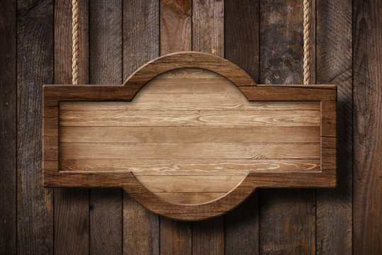 Wooden Sign With Rounded Shape Hanging On Ropes With Wood Planks Background