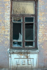 Old window with wooden frame and broken glass.