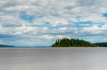 Island Under Blue Skies and Clouds Along Puget Sound, Washington State, USA