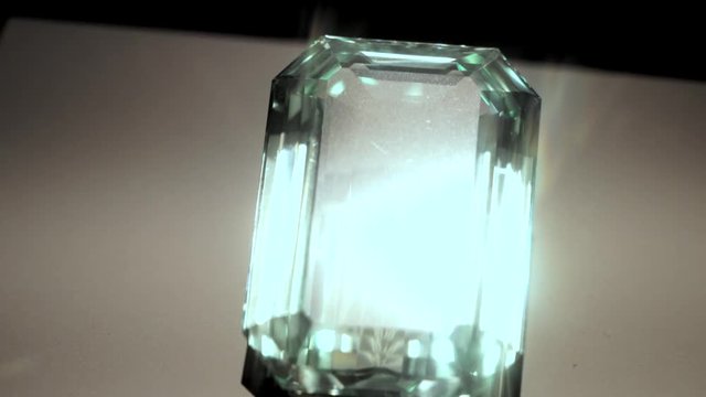 This close up video shows a large rare sparkling aquamarine colored spodumene gem.