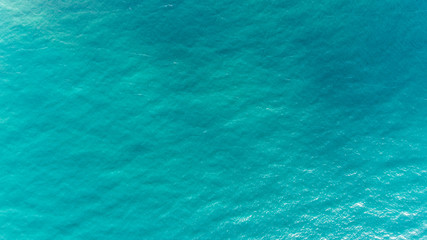 Ocean water texture. Aerial view of sea surface. Top view of transparent turquoise ocean water surface.