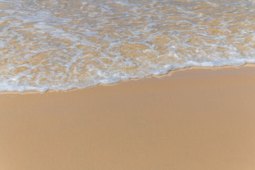 Fototapeta na wymiar Smooth wave at white sand beach.