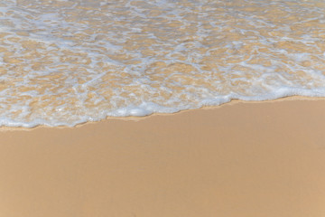 Fototapeta na wymiar Smooth wave at white sand beach.