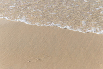 Smooth wave at white sand beach.