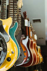 Row of electric guitars In a music instruments shop. Parts of guitar, body