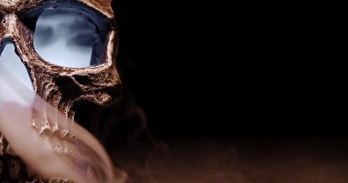 A Smoking Skull  with a white glow only half shown on the left