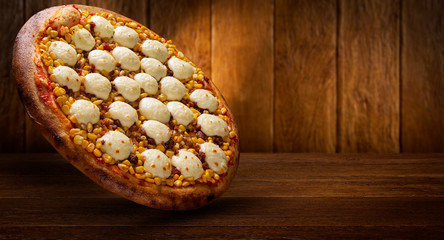 Pizza corn and cheese on wood background. Top view, close up. Traditional Brazilian Pizza.