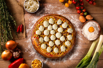 Pizza corn and cheese on wood background. Top view, close up. Traditional Brazilian Pizza.