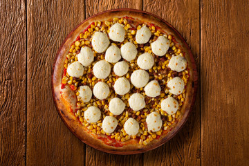 Pizza corn and cheese on wood background. Top view, close up. Traditional Brazilian Pizza.