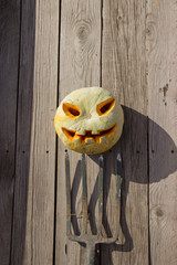 Halloween pumpkin  jack lantern on a pitchfork