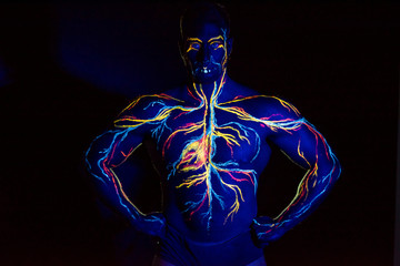 UV picture of the circulatory system body art on the body of an adult male. On the chest of a...