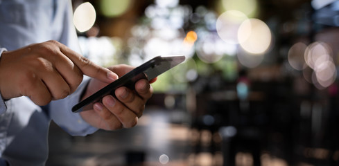 man holding en hands and using digital tablet  Mobile Phone telephone with blank copy space scree