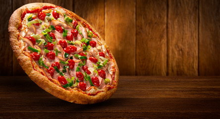 Pizza Turkey breast, Tomato and leek on wood background. Top view, close up. Traditional Brazilian Pizza