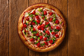 Pizza Turkey breast, Tomato and leek on wood background. Top view, close up. Traditional Brazilian Pizza