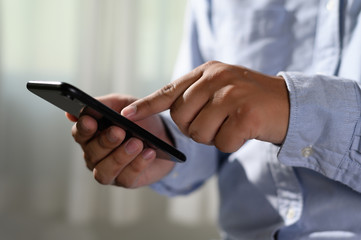 man holding en hands and using digital tablet  Mobile Phone telephone with blank copy space scree