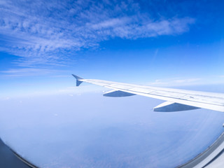 Fototapeta na wymiar The looking at aircraft wing view from windows