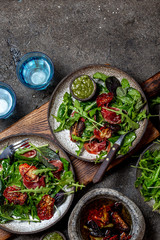Salad with arugula, spinach, dried tomato and ham serrano paleta iberica. Low carbs keto recipe