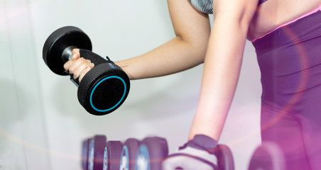Fototapeta na wymiar Concept of fitness.Woman exercising at the gym with dumbbell.Hands with dumbbells.