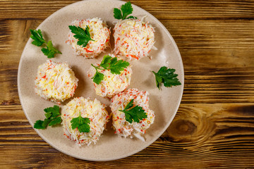 Appetizer of crab-cheese balls on wooden table. Top view