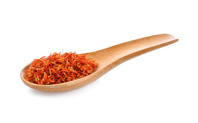 Safflower dried in wood spoon on white background