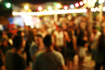 Blurred background of many people had fun at a beach party. Festive concept.