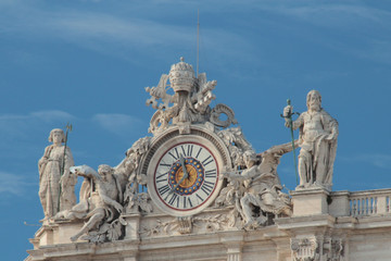 The clock on the facade of the main cathedral of the Vatican, sunny day, bright colors, high...