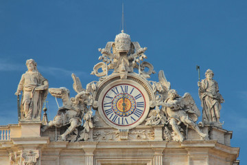 The clock on the facade of the main cathedral of the Vatican, sunny day, bright colors, high...