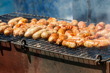 Sausages cooking on a grill