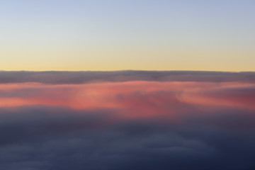The blue skyline with cloudy in sunrise time, view from window on the plane.