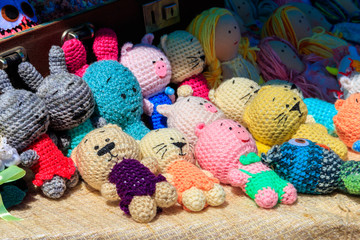 Fototapeta na wymiar Group of handmade soft fabric toys for sale