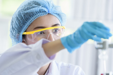 Naklejka premium Asian young girl student scientist researching and learning in a laboratory.