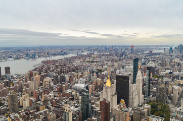 Fototapeta premium New York City skyscrapers rooftop urban view with sky and cloudy background.
