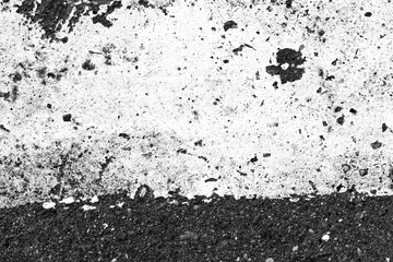 Asphalt surface with old paint on it close up. Abstract background black and white
